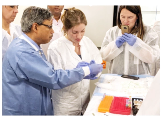 Arun Dhar teaching students in a laboratory