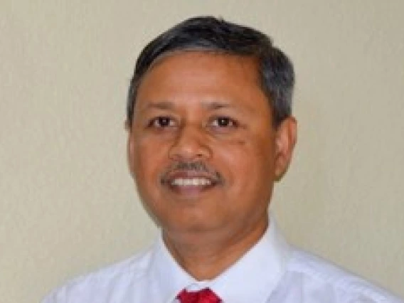 An Image of Arun Dhar in a white shirt and red tie