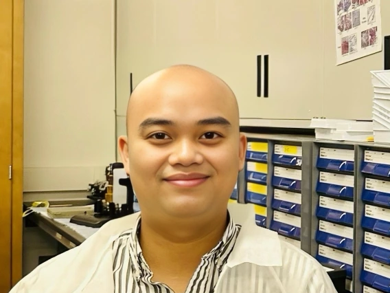 Henry next to a computer with a histology image