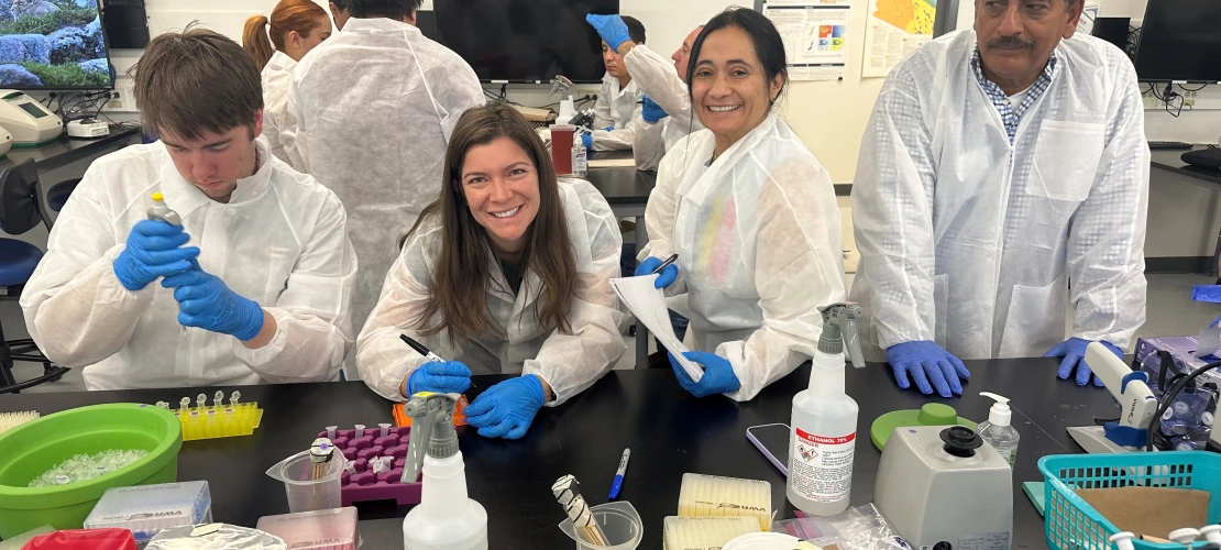 Image of people in lab coats performing PCR