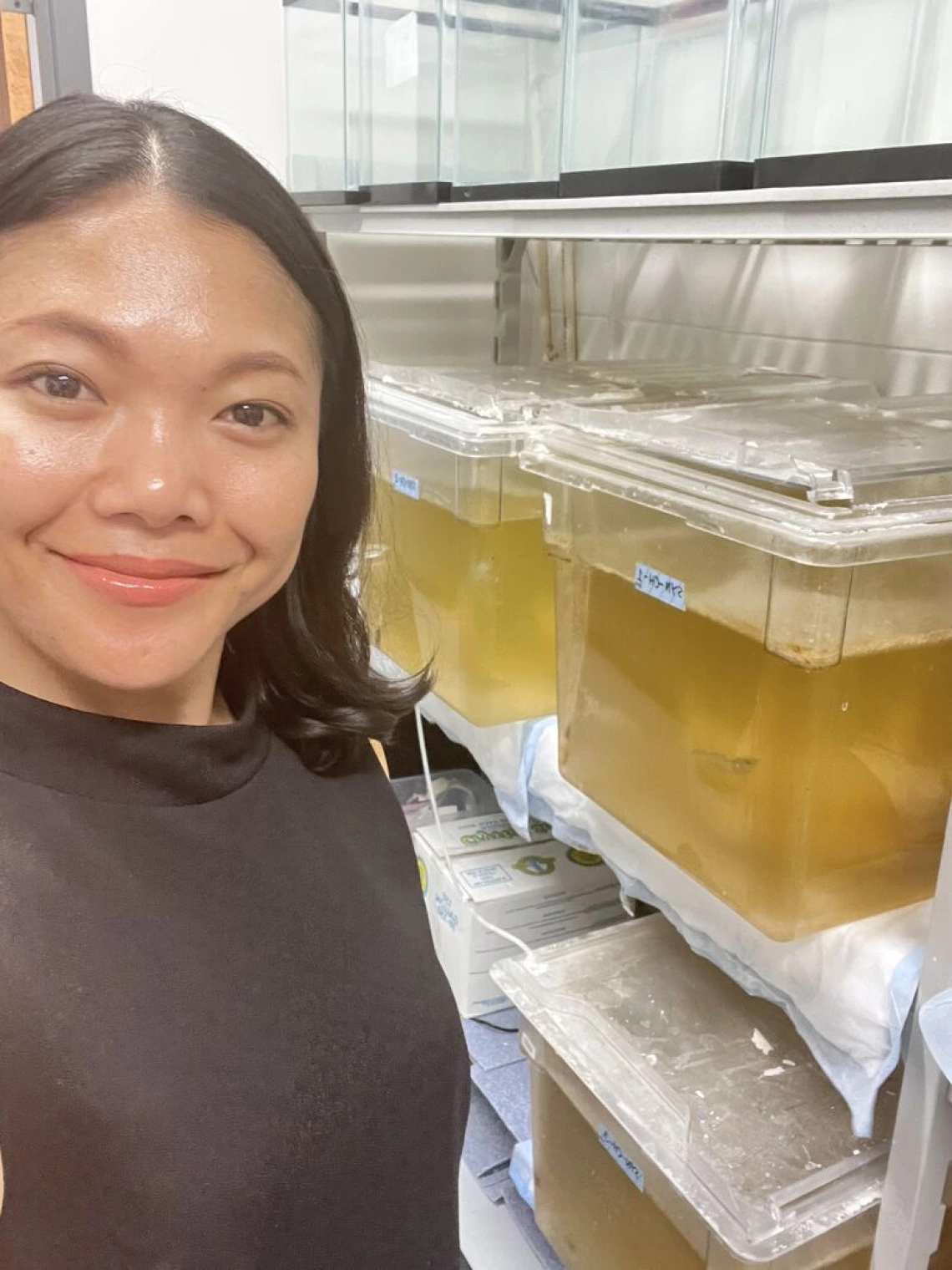 Dr. Magdalena Lenny Situmorang in front of tanks with shrimp