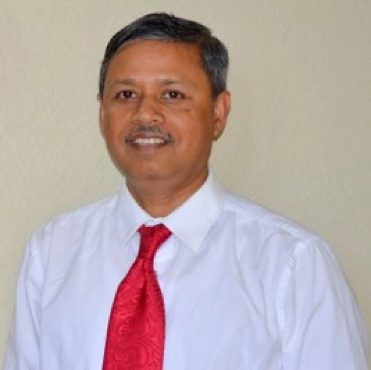 An Image of Arun Dhar in a white shirt and red tie