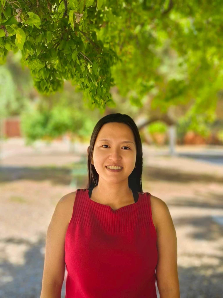 Image of Thi Huynh in front of some trees