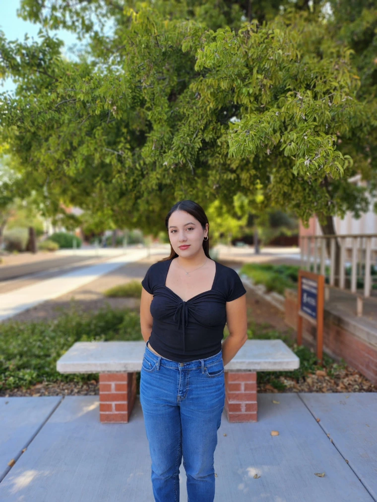 Image of Marian in front of a green tree